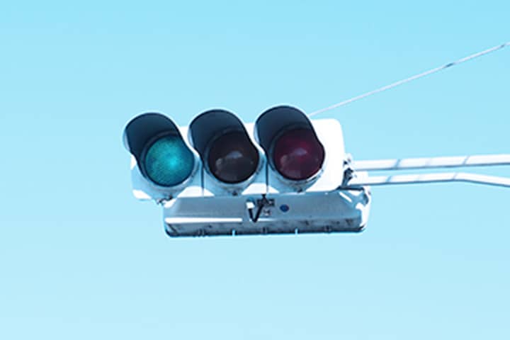 交通信号機・道路情報制御システム工事のイメージ：青空をバックにした信号機の写真